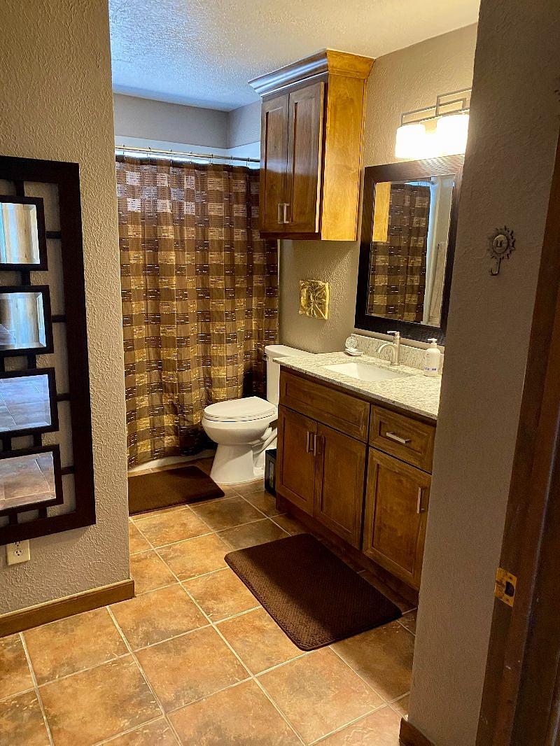 Community bathroom with direct access to coastal bedroom