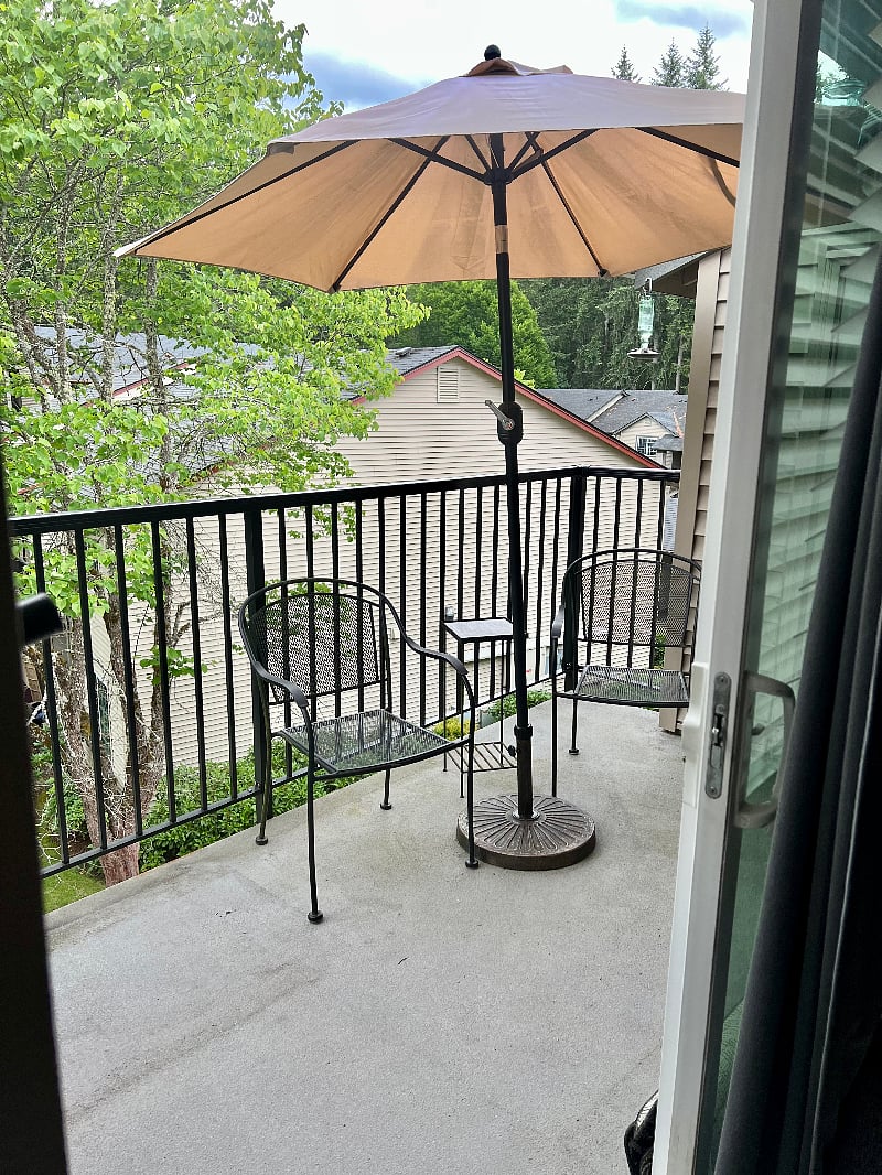 Patio with chairs and umbrella