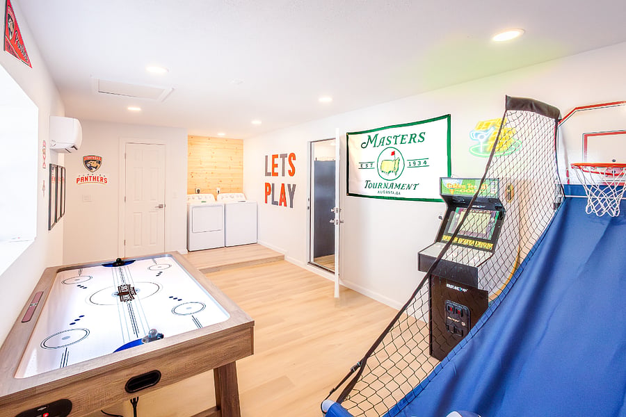 In-unit washer and dryer plus a game room with air hockey, arcade cabinet, and basketball. Handle laundry and decompress in one space.