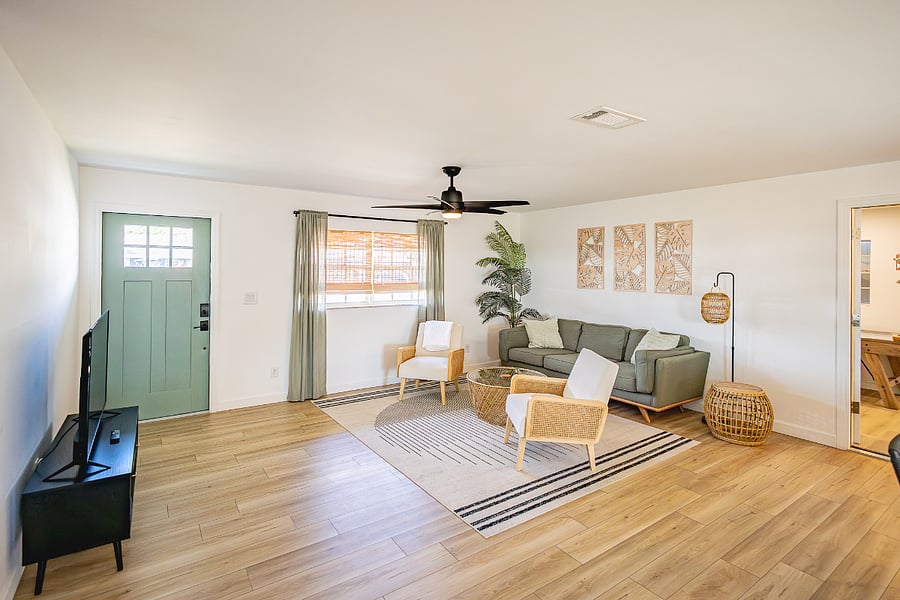 Spacious living room with smart TV, comfortable seating, and modern coastal decor. Plenty of room to feel at home.