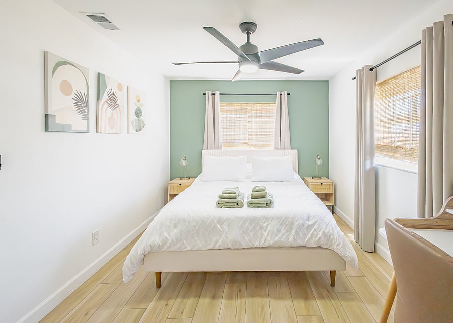 Queen bed with premium linens in the primary bedroom. Restful coastal decor and a dedicated workspace for remote work.