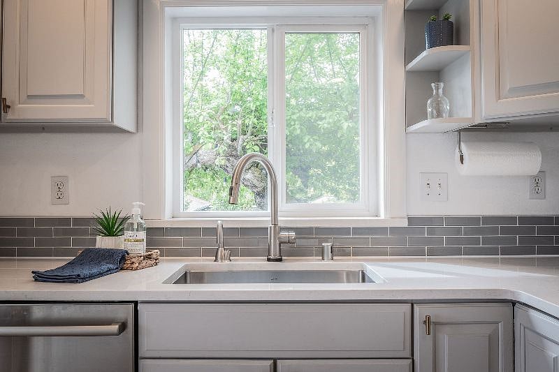 Kitchen with dishwasher and sink with instant hot water tap.