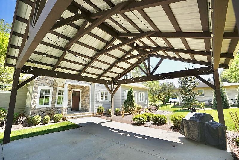 Carport with string lights and grill. Has also been updated with outdoor furniture after photo was taken. 