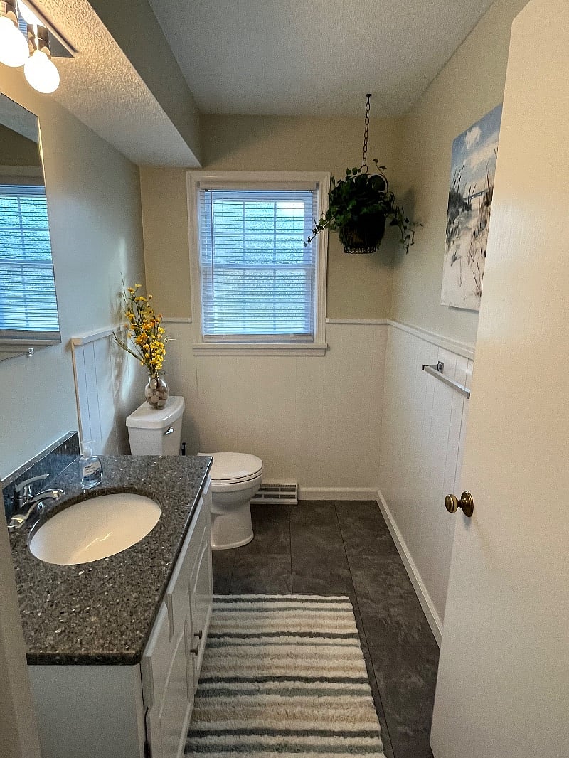 1st floor half bathroom located between kitchen and garage. 