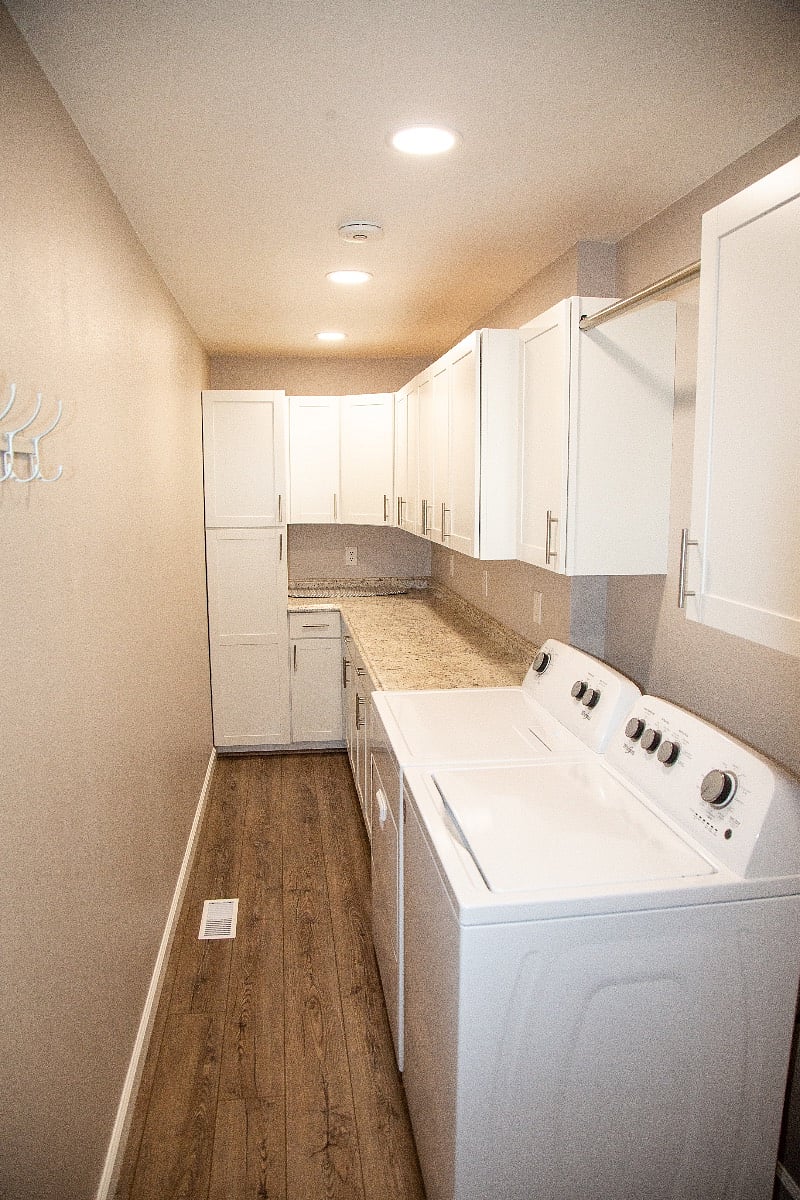 Full laundry room with plenty of storage and washer/dryer