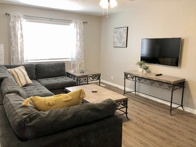Living room with sectional couch and wall mounted 50 smart fire tv