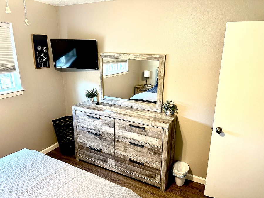 Bedroom #2 with queen bed, dresser, nightstand and smart TV.