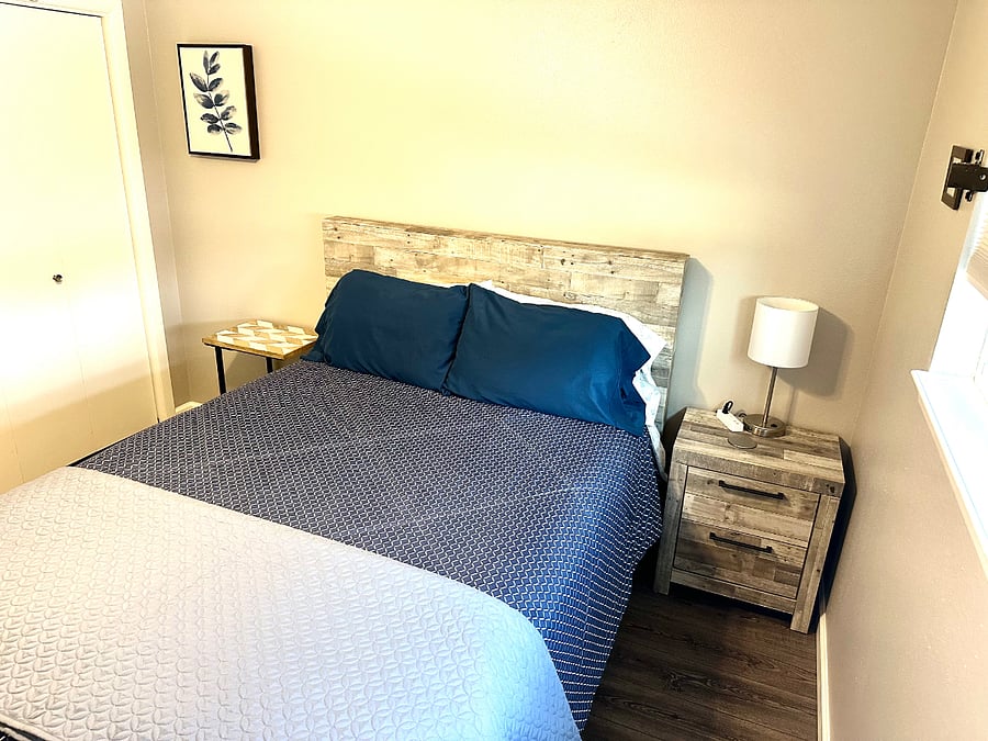 Bedroom #2 with queen bed, dresser, nightstands and smart tv