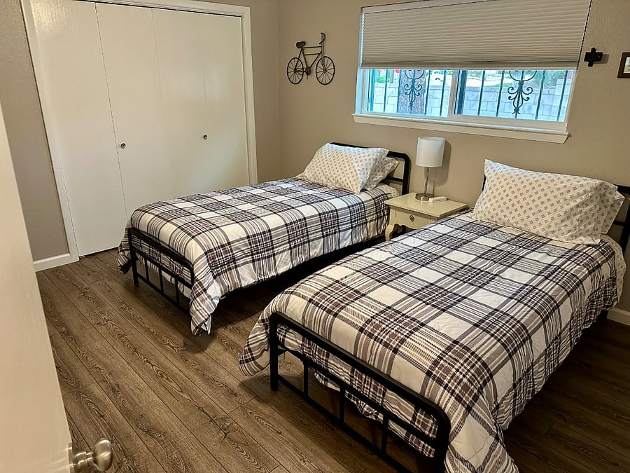 Bedroom #3 with 2 twin adult xl beds, nightstand, dresser and smart tv