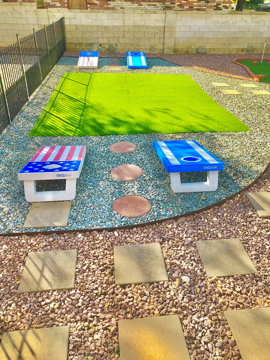 Backyard with corn hole games