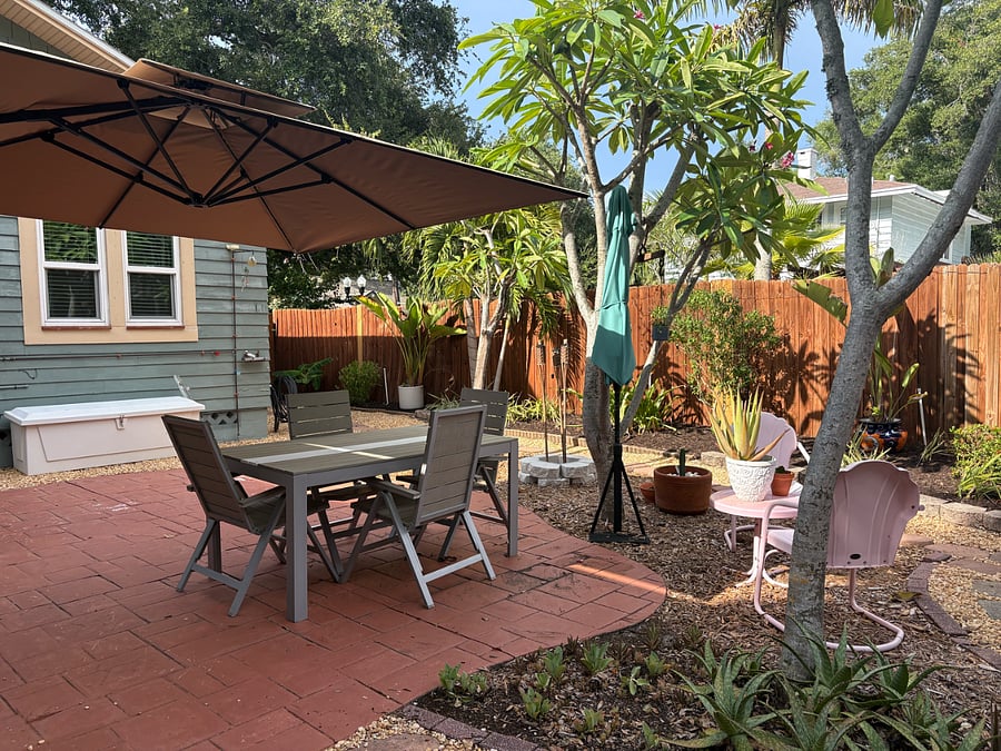 Large outdoor space with dining, outdoor shower