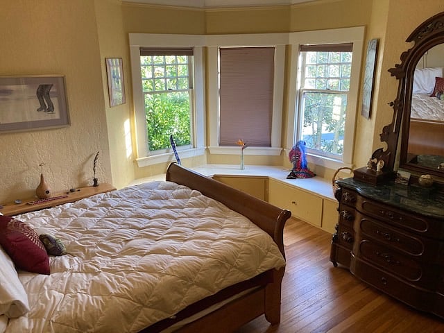 Master bedroom with queen sleigh bed, bay windows and sill sitting space.  Tons of storage, walk-in closet, hand carved antique Exercise dresser, and more.