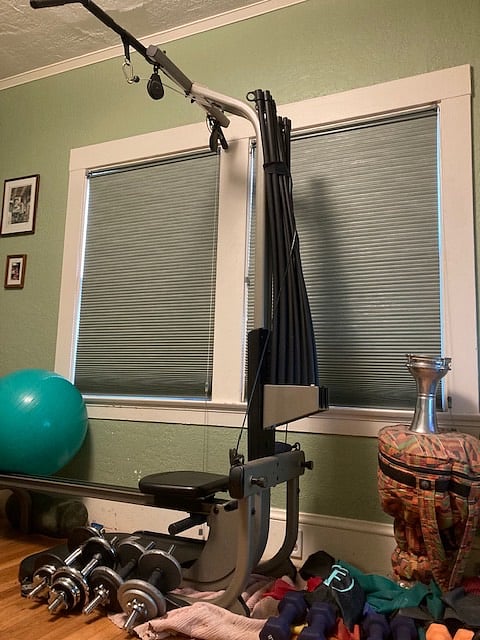 Exercise area includes complete set of 12 dumbbells, bands, bowflex rowing/weight machine, balance ball, yoga pads/equipment, & back roller.