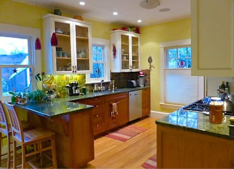 Completely remodeled kitchen with top of line appliances, granite counters, 2 sinks, African tile backsplashes, Decor stove, quiet dishwasher, and equipped for the gourmet chef in you.  Dozens of spices, coffee center, wood floors & light from 3 windows and glass doors.