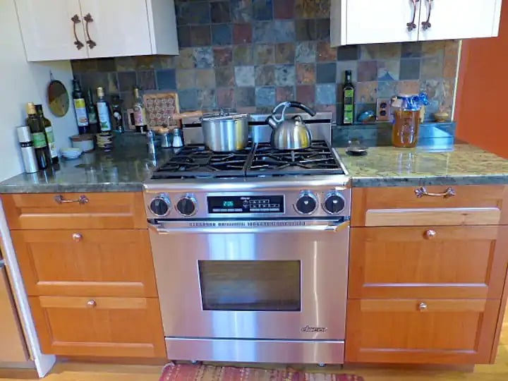 Decor stove with overhead fan & plenty of counter space on either side.