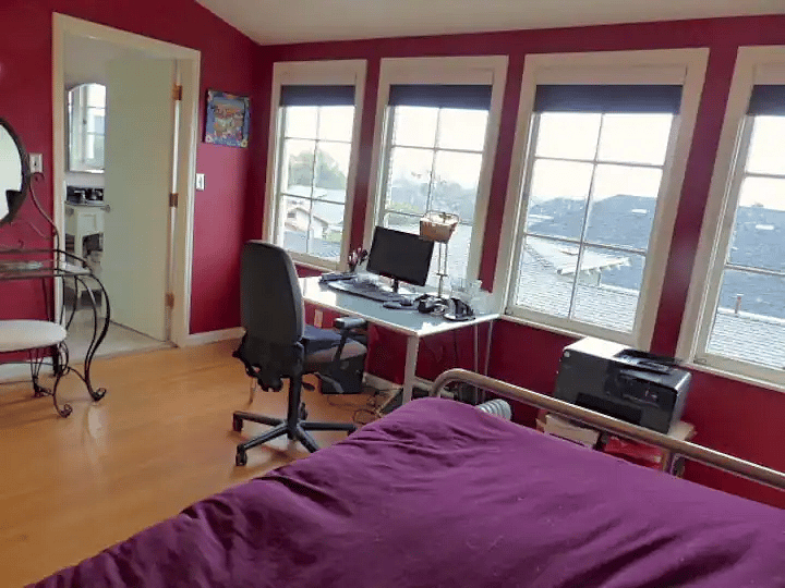 Bedroom 2--large with bank of 4 large windows, ensuite bathroom, armoire, desk/monitor, and European Sleepworks queen bed.