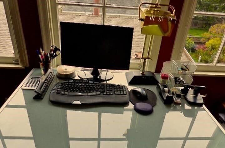Downstairs adjustable height desk area with ergonomic chair.