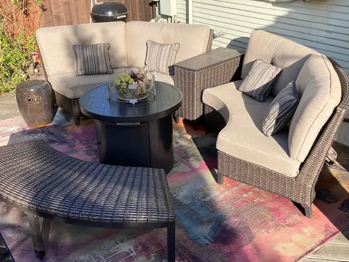 Backyard living room furniture, fire table, and deck.
