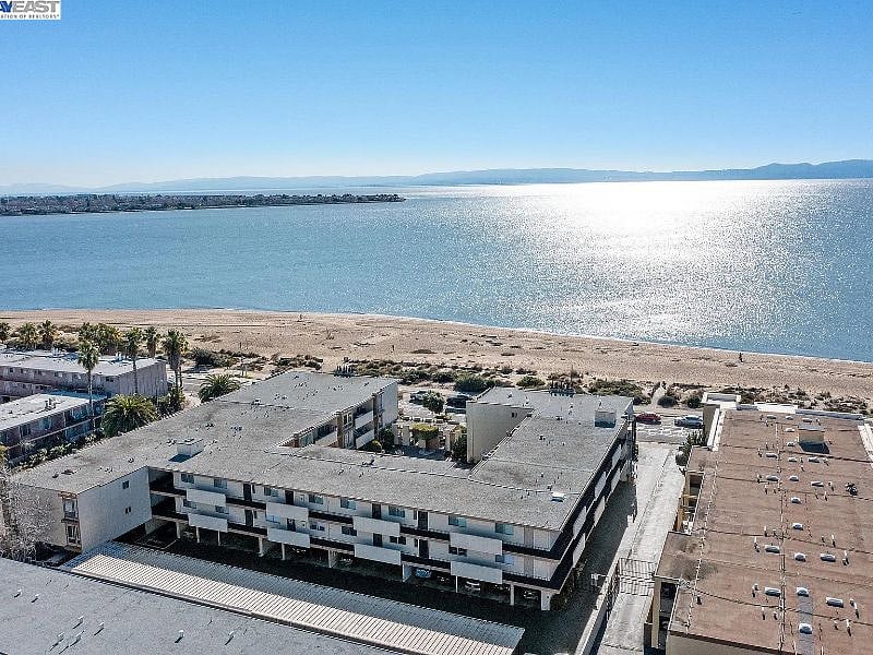 Aerial view of condo complex. Unit directly faces Shoreline Beach.