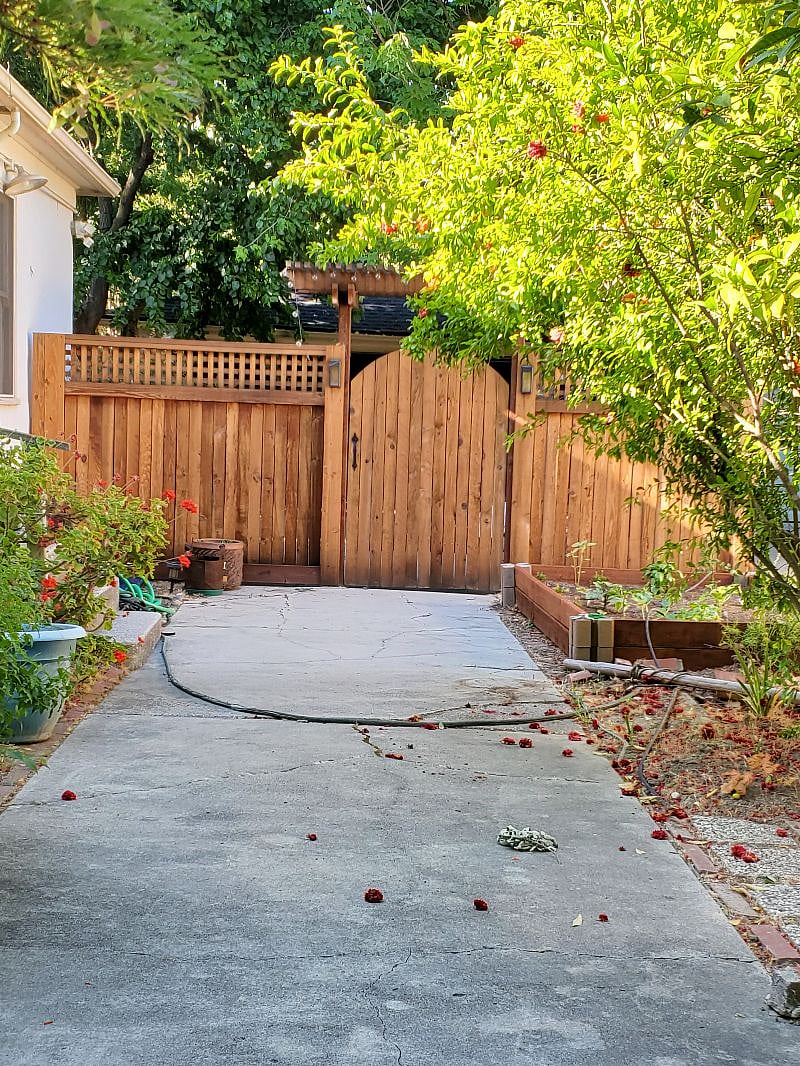 Gate at end of driveway leading to back yard. 