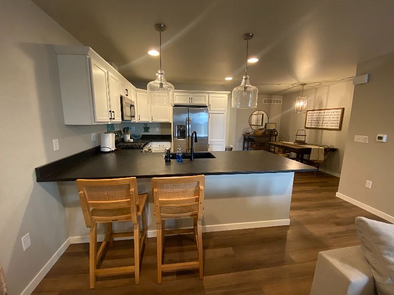 View from kitchen, into dining area, and back to door through the garage.