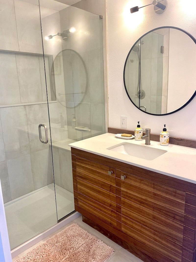 Luxurious bathroom with a walk in shower & bench.