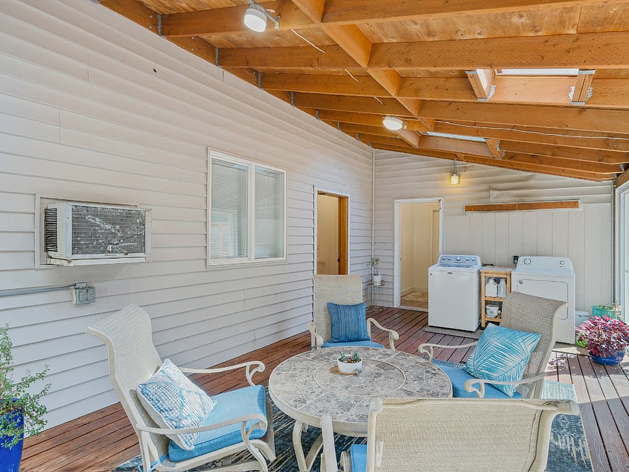 Enter the building thru a sunroom with washer / dryer for the guest apartment.