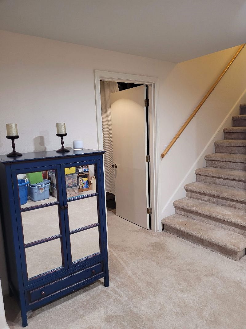 Stairs down into living area. Door is into bathroom and bedroom.