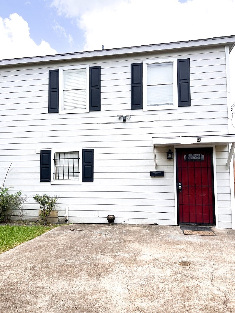 Exterior front of house. Smart lock behind security door gate.