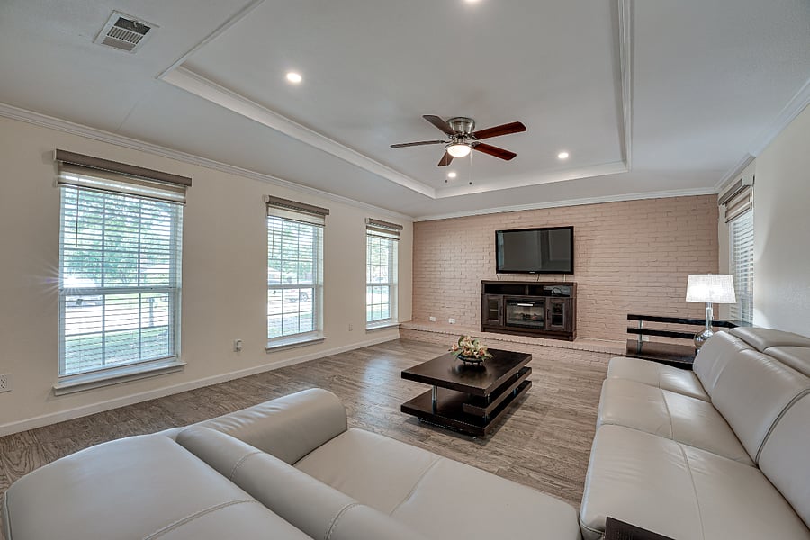 Living room with 65 inch TV with 400 over 400 channels, Sofa and a recliner.