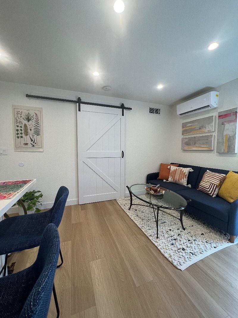 Barn door opens up to bedroom from kitchen and living areas.