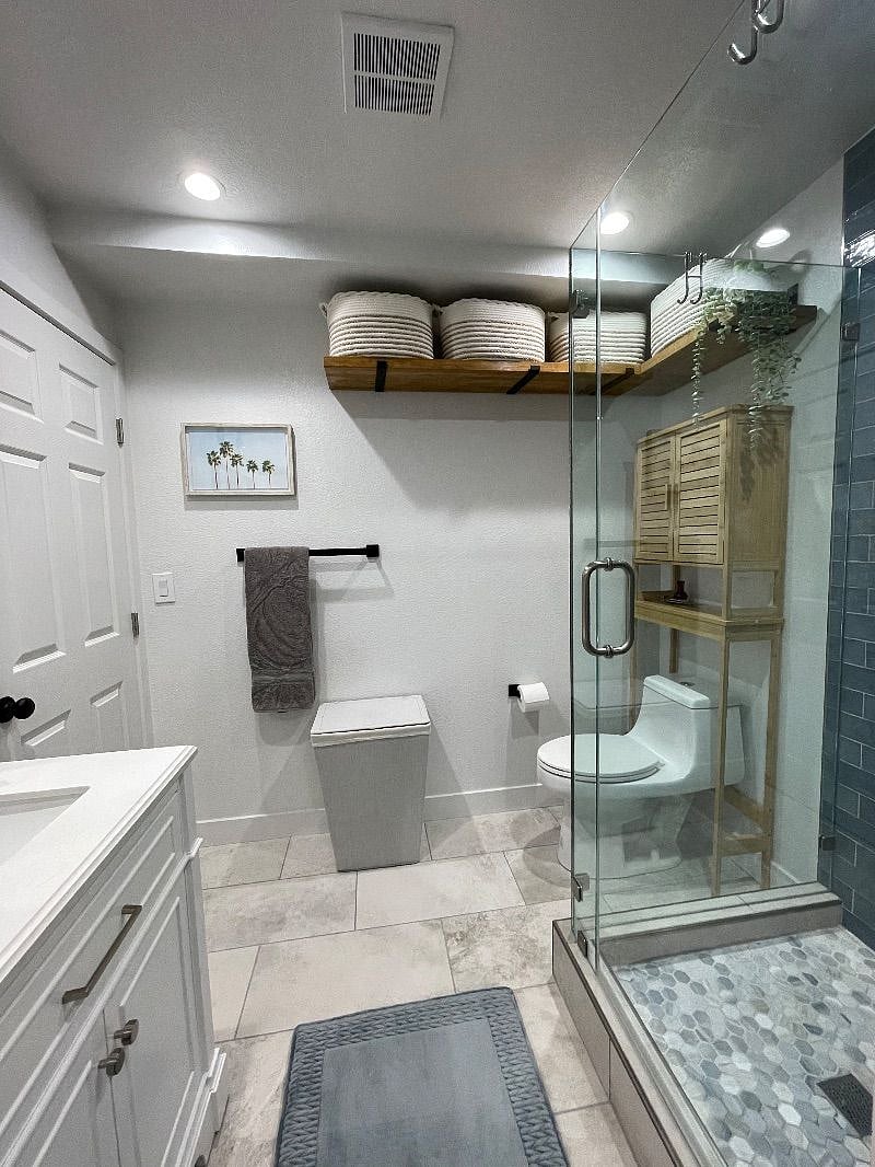 Newly constructed bathroom with designer finishes and in-house washer/dryers through pictured door. Ample storage space.