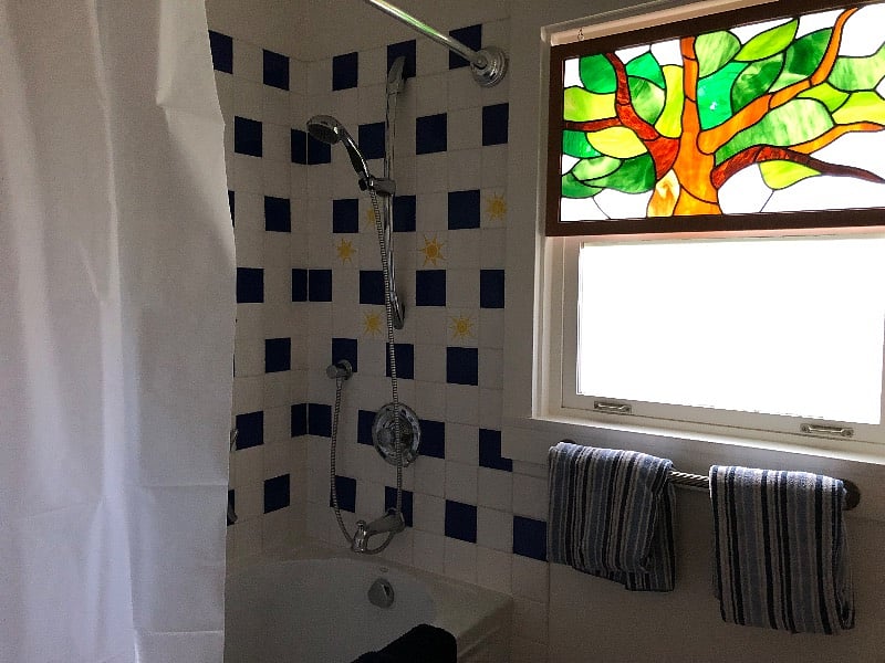 Bathroom with tile and stained glass window