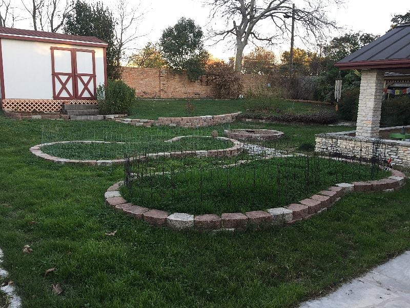 Fenced back yard with plenty of room for dogs to run around. Covered patio features a hammock to lounge in.