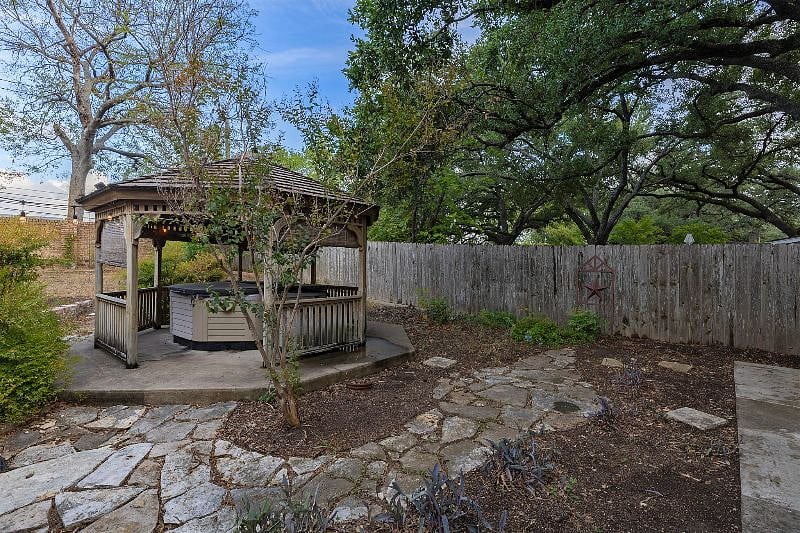 Back yard features a hot tub