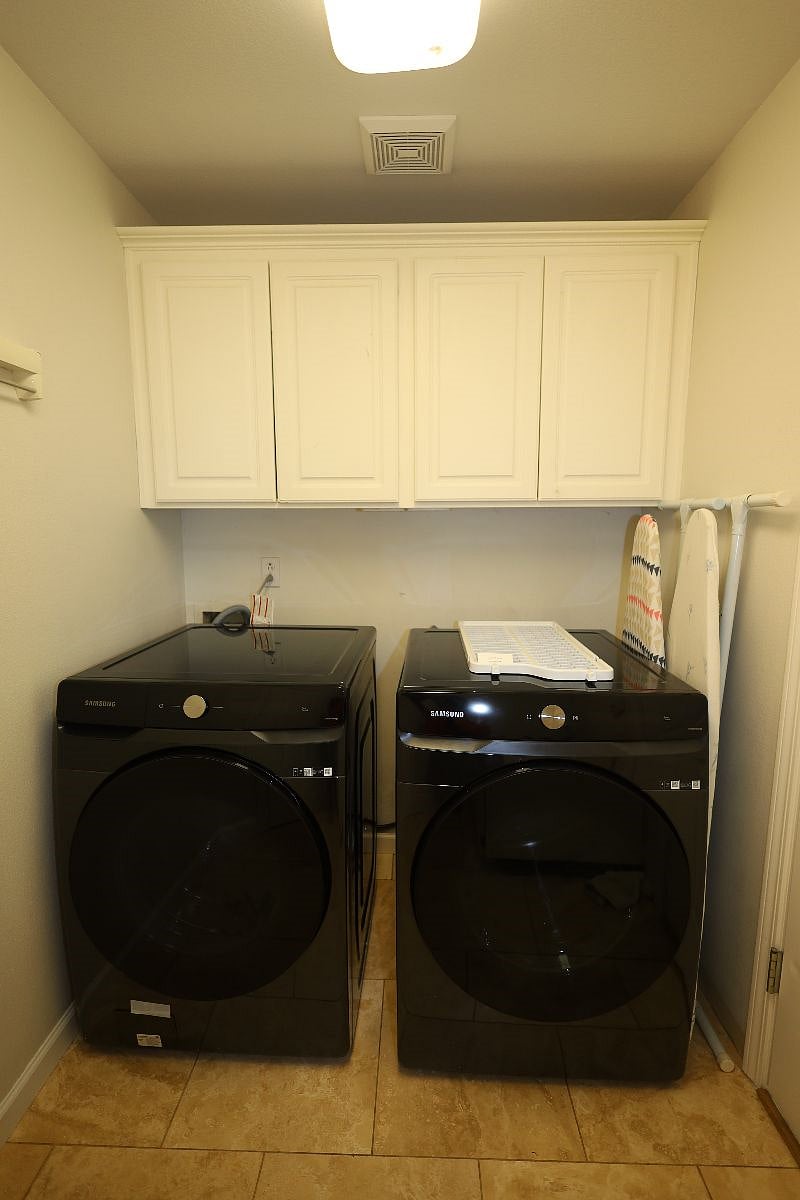 New Samsung energy efficient washer, dryer with a wash basin sink in the Laundry room