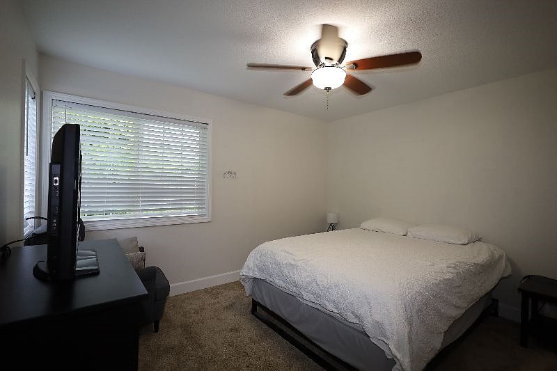 Bedroom-3, 12'x11', Queen bed, dresser, chair, 32" TV, closet, end tables with lamps