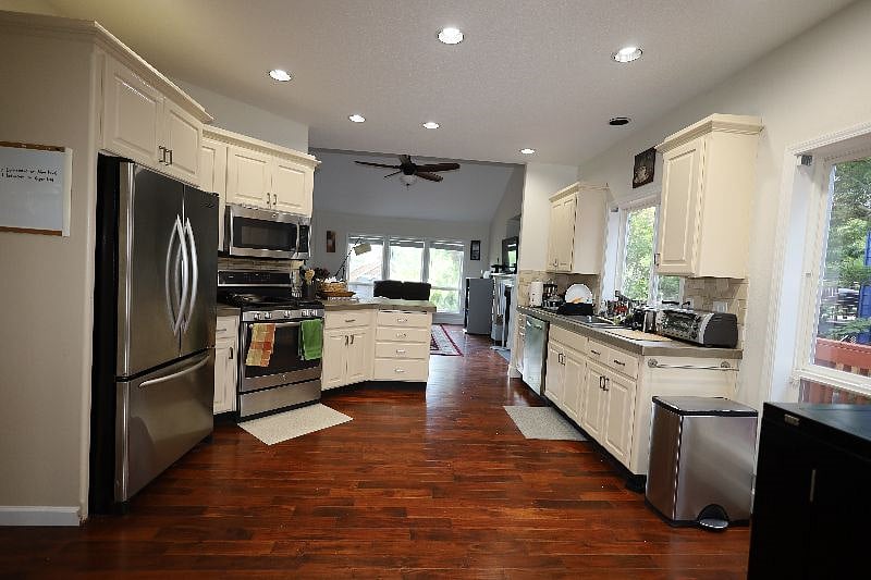Fully stacked kitchen with Microwave, Gas Stove, Oven, Toaster, Vitamix, Mixer, cutlery, plates, dish washer, sink, dish rack, cleaning supplies, trash can etc.