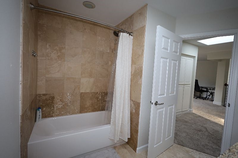 Shared Bathroom - double sink with vanity mirror, toilet and bathroom