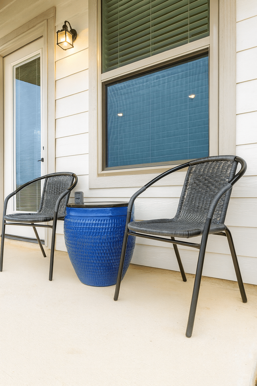 Step outside to your private sanctuary: a fully fenced backyard with comfortable patio furniture, perfect for relaxing and enjoying the peaceful views of the adjacent grassy field.