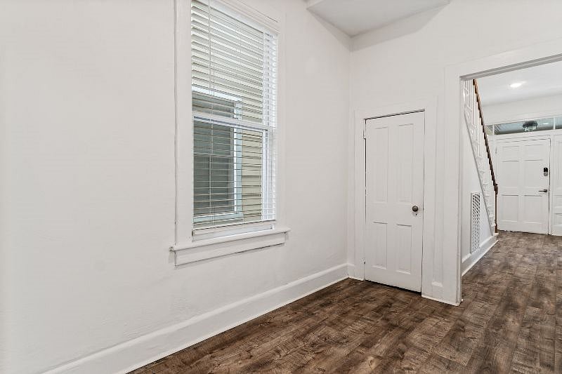 Hallway between front door, Living Room, and Kitchen