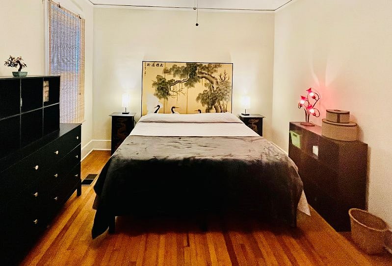 The spacious central bedroom features a king sized bed, ample storage space, clothes drawers and a closet.