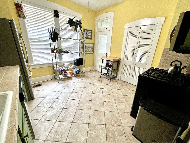 Another view of the kitchen shows the generous pantry and extra rack shelving, great for storage.