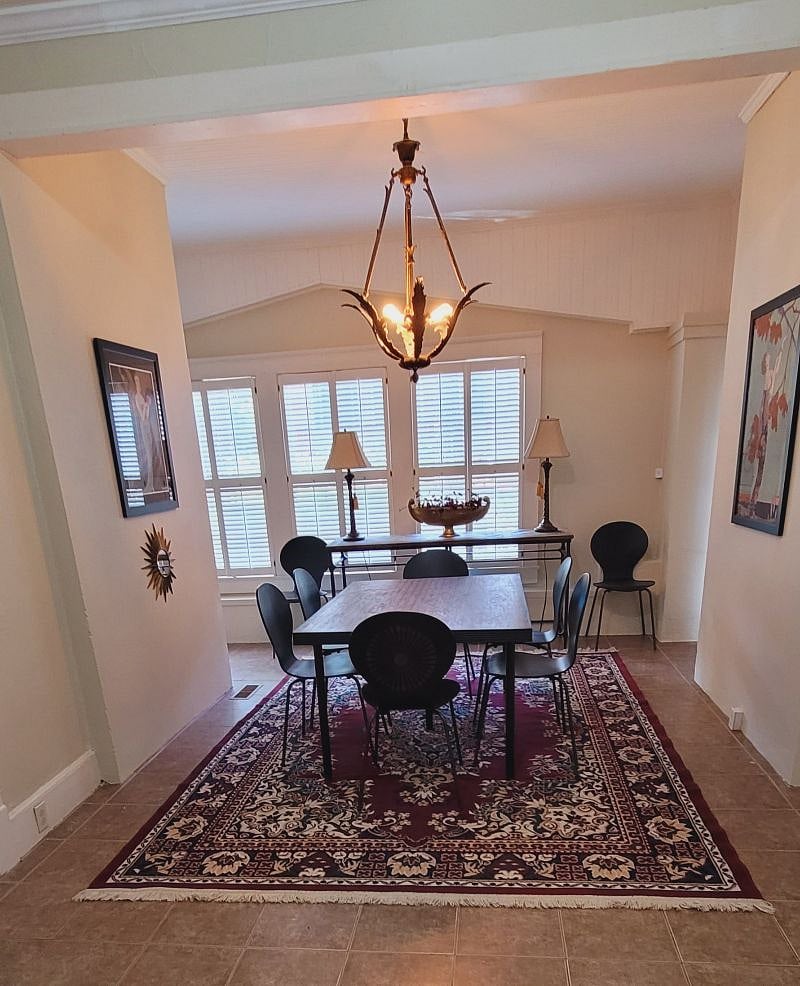 Custom dining table with French antique chandelier