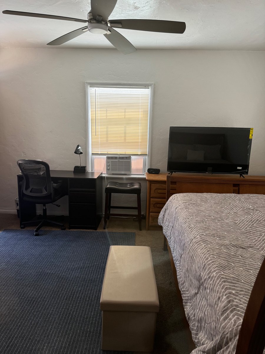 Desk, air conditioning unit and 55 flat screen TV