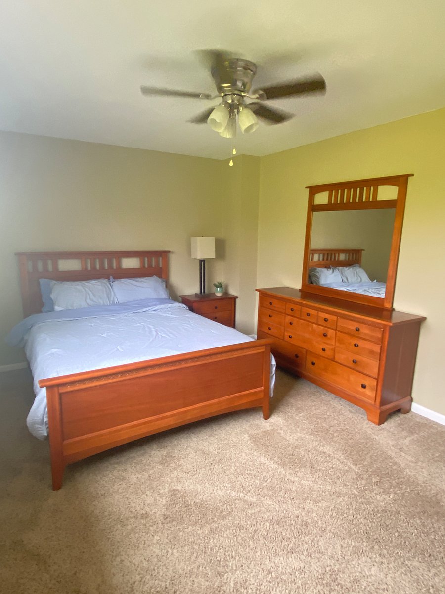 Bedroom #2, with dresser and large closet, back window views a 40 acre lake