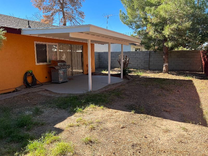 Enclosed backyard with patio area