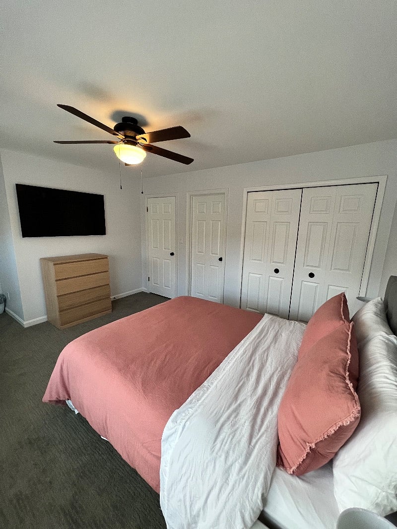 Bedroom 1 with large tv and a comfortable queen sized adjustable bed offering the the convenience of changing the angle of the head section to achieve various positions for reading, watching tv or simply finding a comfortable sleeping position. 