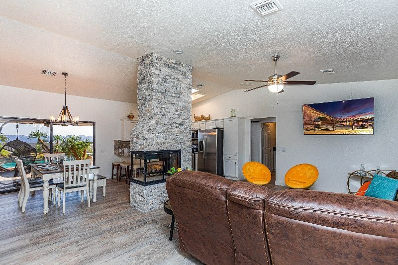 Living room area with Roku TV very comfortable sofa with reclining features.
j