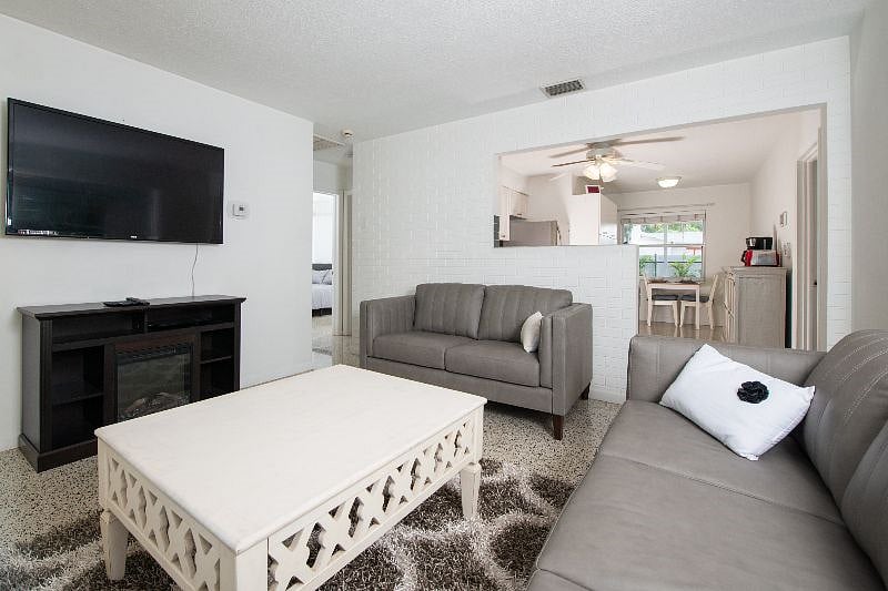 living room with view of kitchen and 2 bedrooms